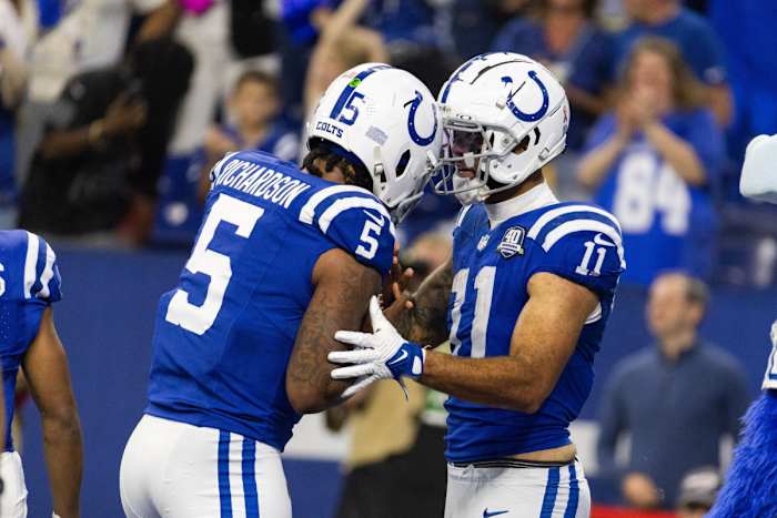Sep 10, 2023; Indianapolis, Indiana, USA; Indianapolis Colts wide receiver Michael Pittman Jr. (11) gives his touchdown ball to quarterback Anthony Richardson (5) after scoring his first passing touchdown in the second half against the Jacksonville Jaguars at Lucas Oil Stadium.